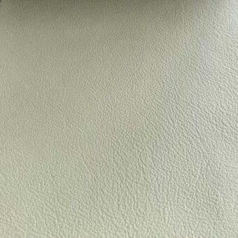 Rugiano leather swatch, pale off-white, fine grain texture, matte finish, consistent pattern, durable material, diffused lighting.